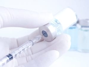 A syringe full of dermal filler product